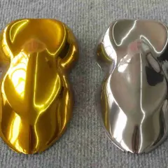 Due campioni di vernice, uno oro brillante e l'altro con un effetto cromo colore metallico, riflettono la luce su una superficie grigia.