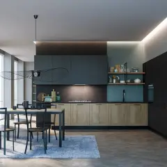 Elegante cucina ottanio e legno con isola centrale, tavolo da pranzo e illuminazione moderna.