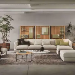 Soggiorno moderno con divano componibile color crema, poltrone in rattan e pareti color tortora chiaro e scuro.