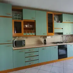 Cucina con ante in legno verniciate di azzurro, un progetto di restyling per rinnovare l'aspetto.