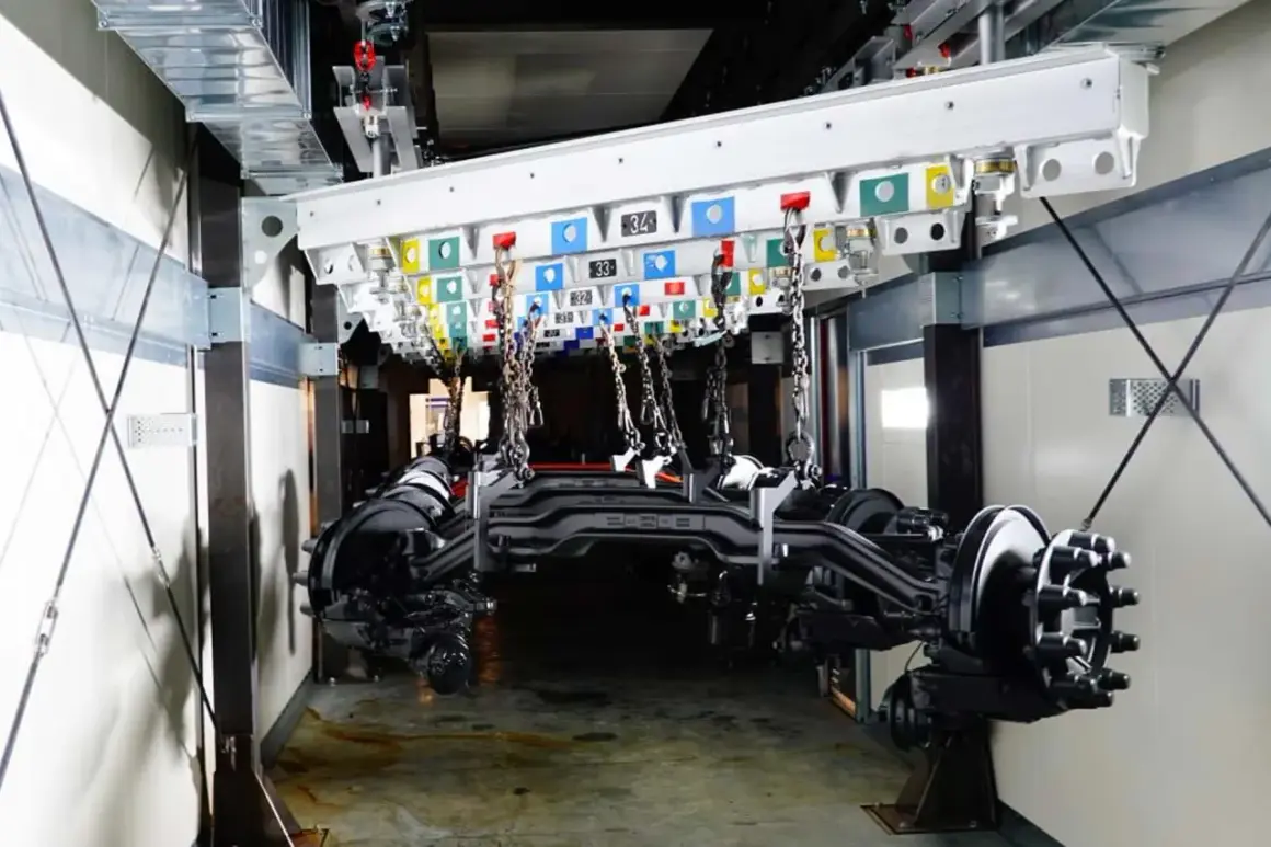 Assali di camion in sospensione pronti per la verniciatura. Il sistema di trasporto aereo è pronto per la verniciatura dei camion.