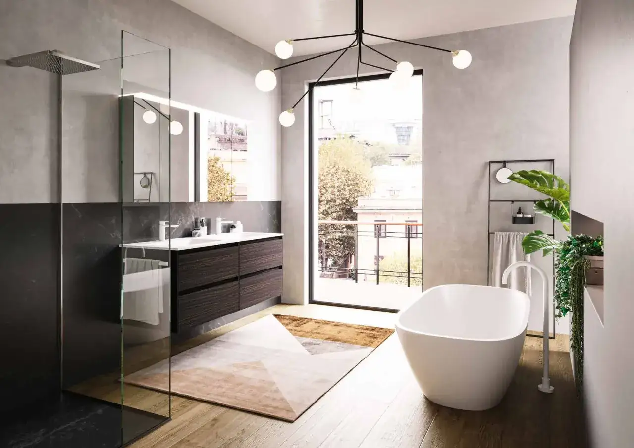 Bagno moderno con vasca freestanding, doppio lavabo e doccia walk-in. I colori per bagno spaziano dal grigio cemento al legno scuro, con accenti dorati nel tappeto geometrico.