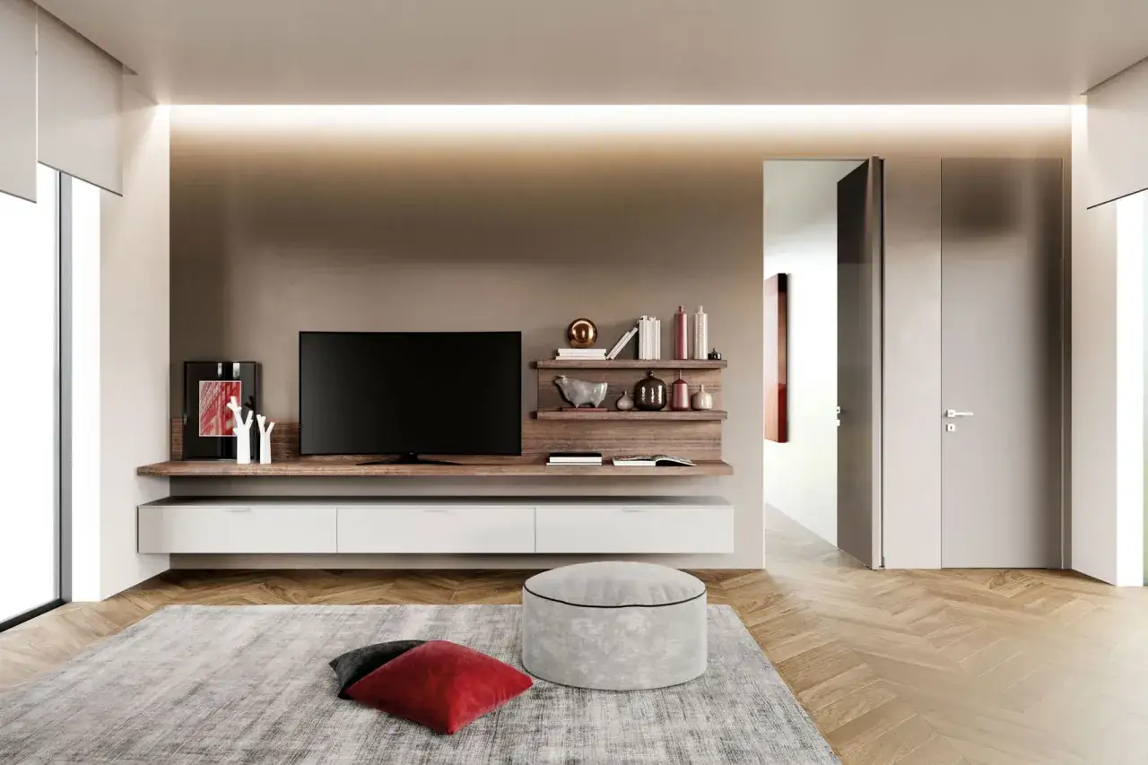 Soggiorno moderno con pareti color tortora chiaro e scuro, mobile TV sospeso, tappeto grigio e pouf.